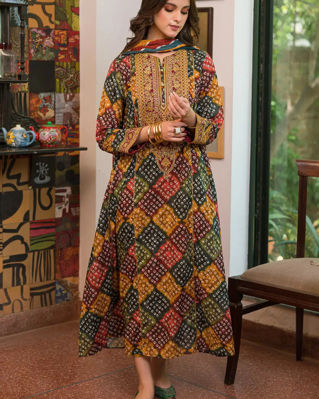 Woman wearing a colorful patterned dress in an indoor setting.